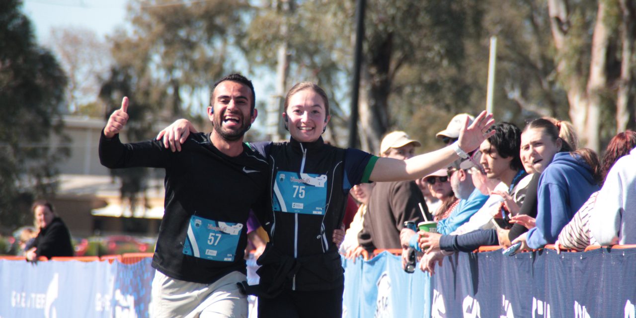 Two runners celebrating at the finish line